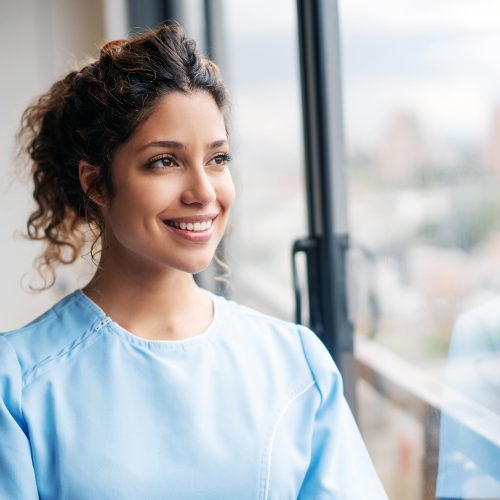 Portrait of a Latin American home caregiver looking thoughtful and smiling â medical concepts